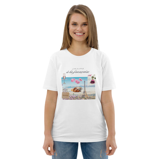Woman wearing white graphic tee with Parisian design — soft pink and blue illustration with Eiffel Tower, macarons and rose, Island of Calm brand