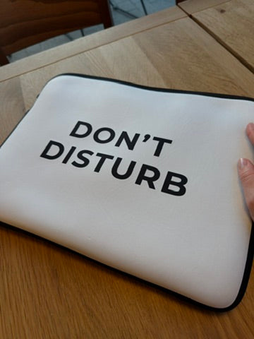 Minimalist laptop sleeve protecting laptop on desk workspace