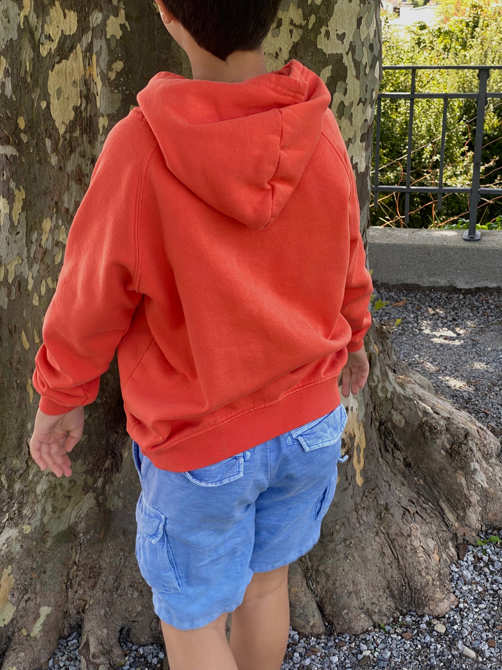 Back of kids eco-friendly hoodie made with organic cotton and recycled polyester, cozy sustainable children’s clothing