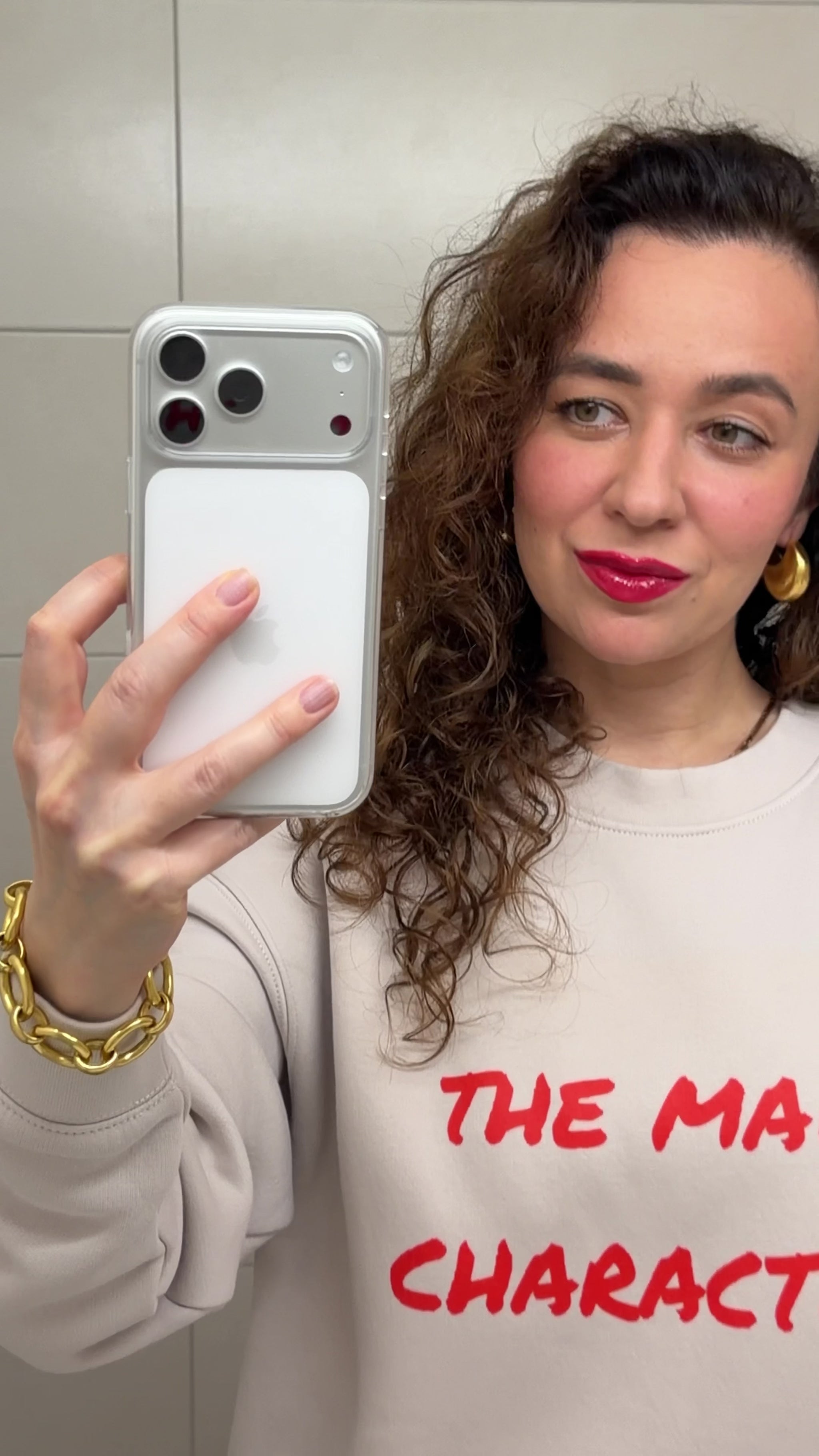 Woman styling a unisex relaxed crew neck sweatshirt with “the main character” print