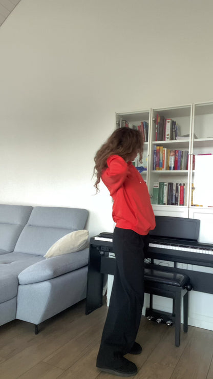 Video with a woman in a soft orange unisex hoodie with “joy keeper” embroidery on the sleeve, made from organic cotton — eco-friendly minimalist sweatshirt.