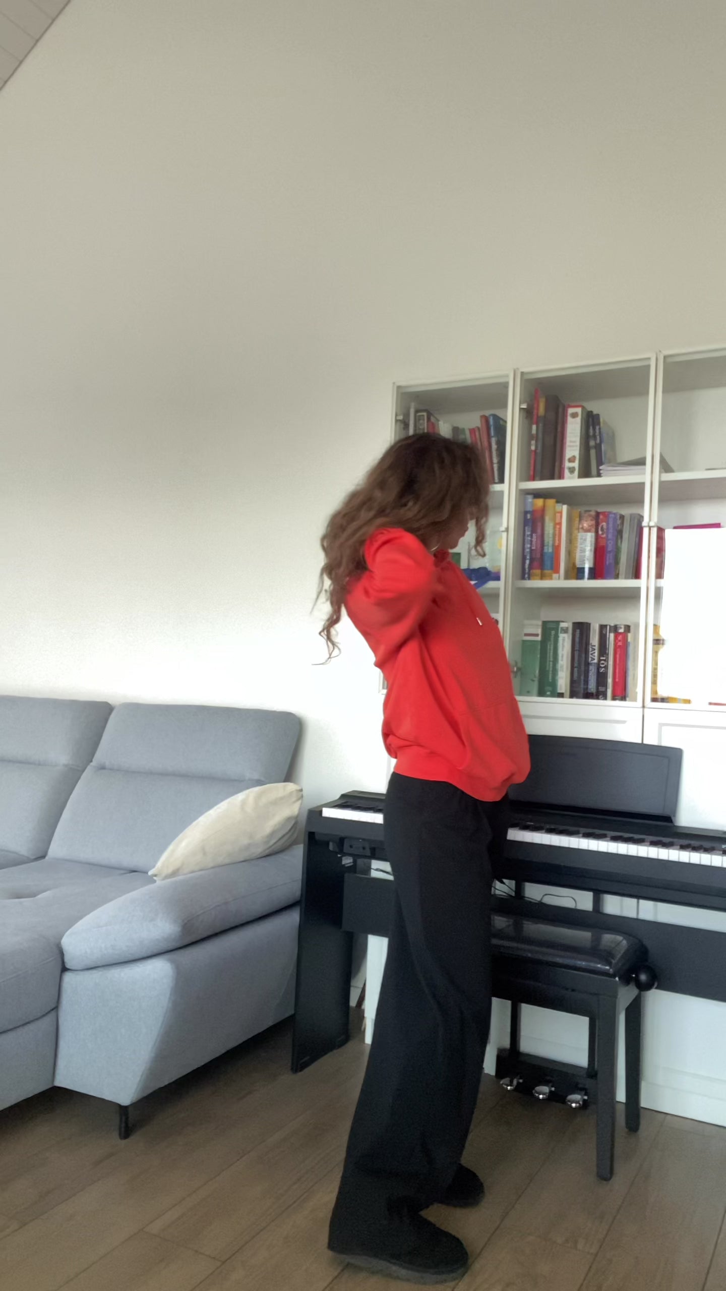 Video with a woman in a soft orange unisex hoodie with “joy keeper” embroidery on the sleeve, made from organic cotton — eco-friendly minimalist sweatshirt.