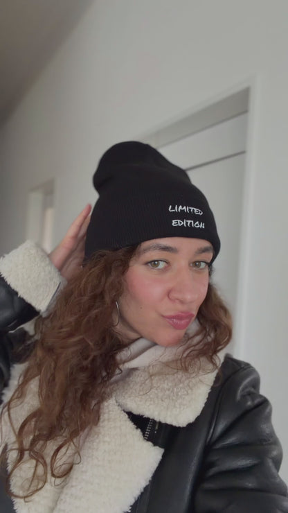Video of a woman wearing a black embroidered limited edition beanie in a casual outfit