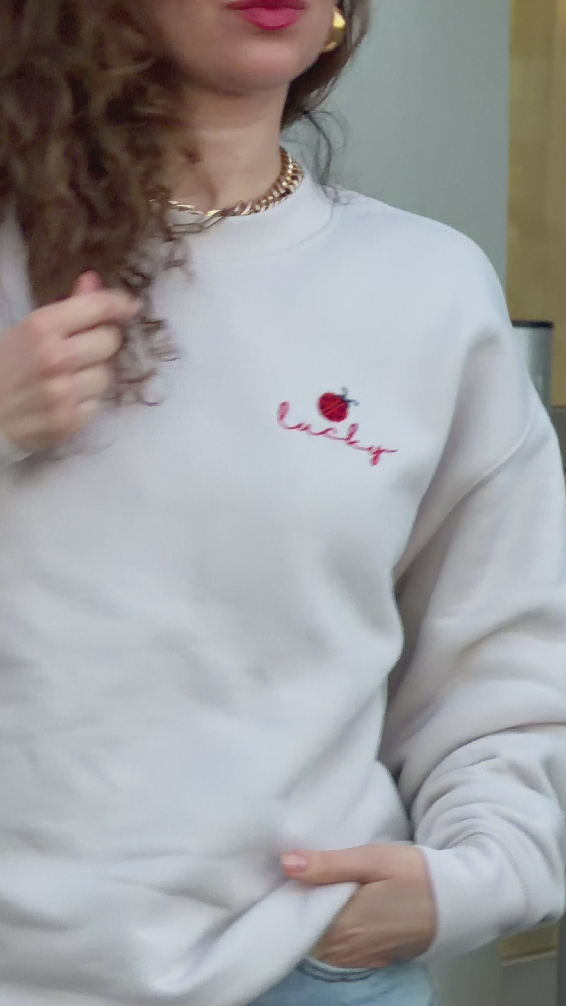 Video of woman wearing Lucky ladybug embroidered sweatshirt in relaxed everyday styling