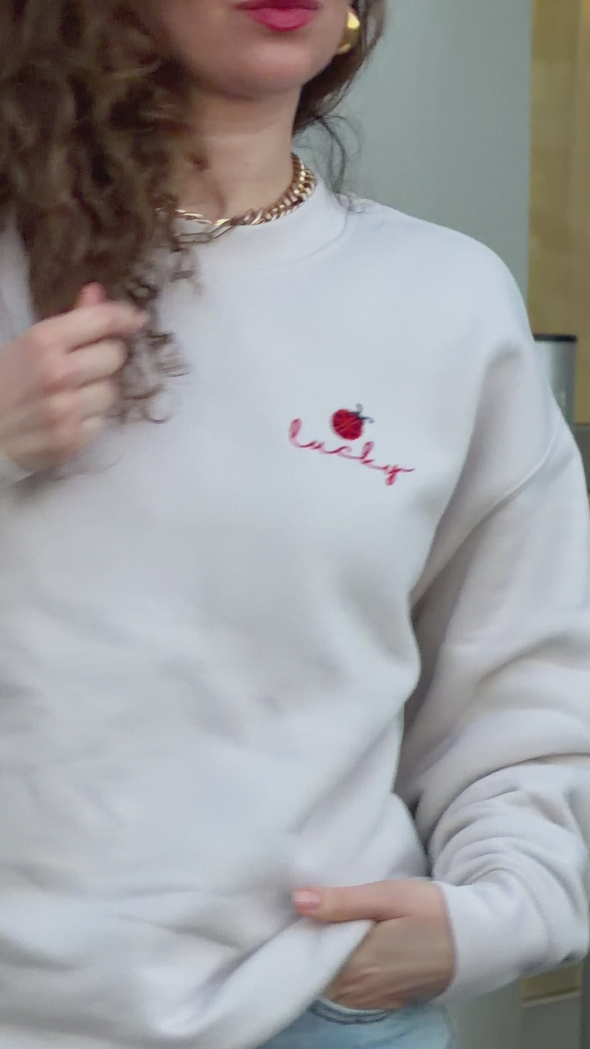 Video of woman wearing Lucky ladybug embroidered sweatshirt in relaxed everyday styling