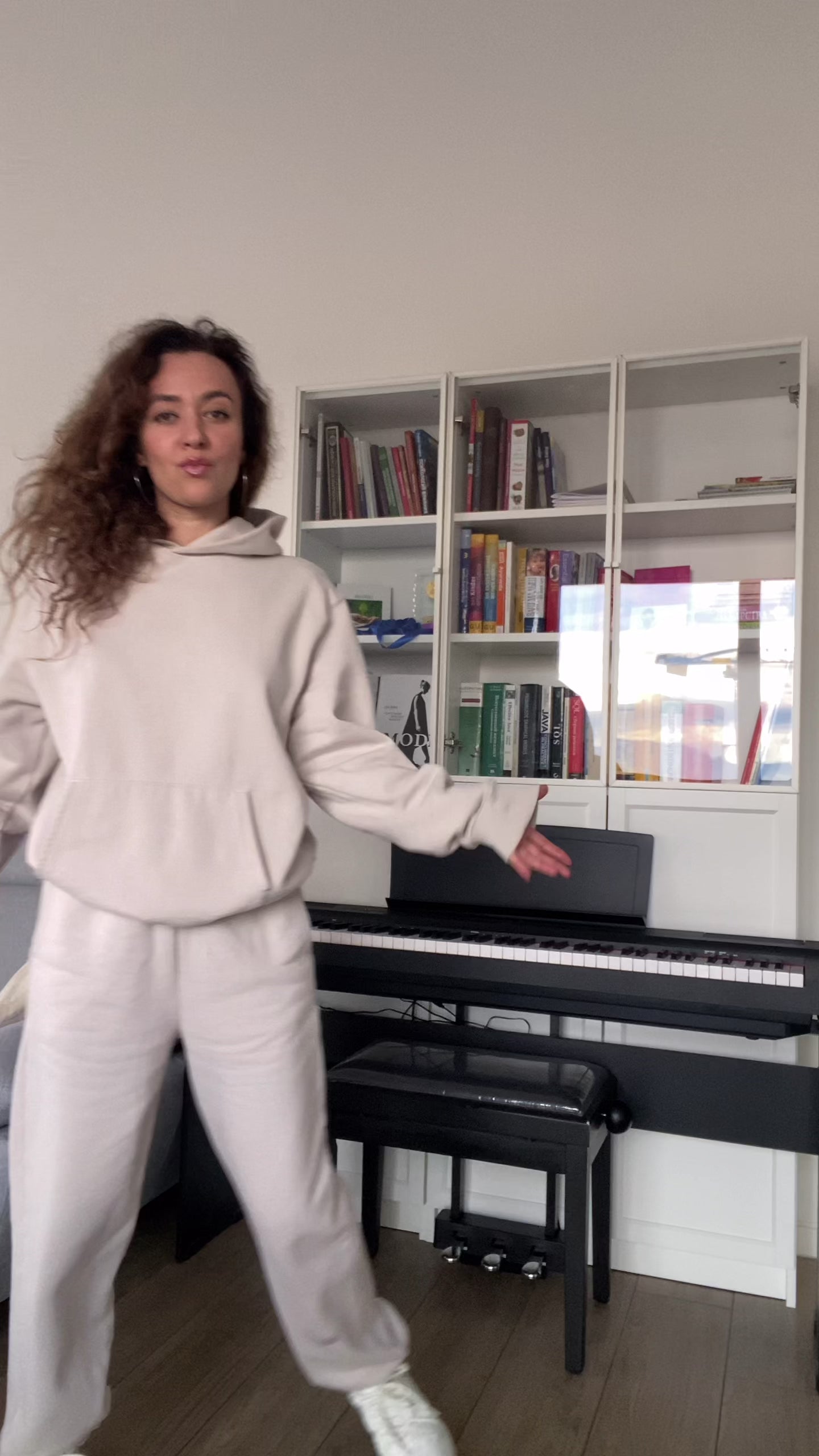 Model wearing oversized hoodie in Dust, styled with matching sweatpants for cozy loungewear look.