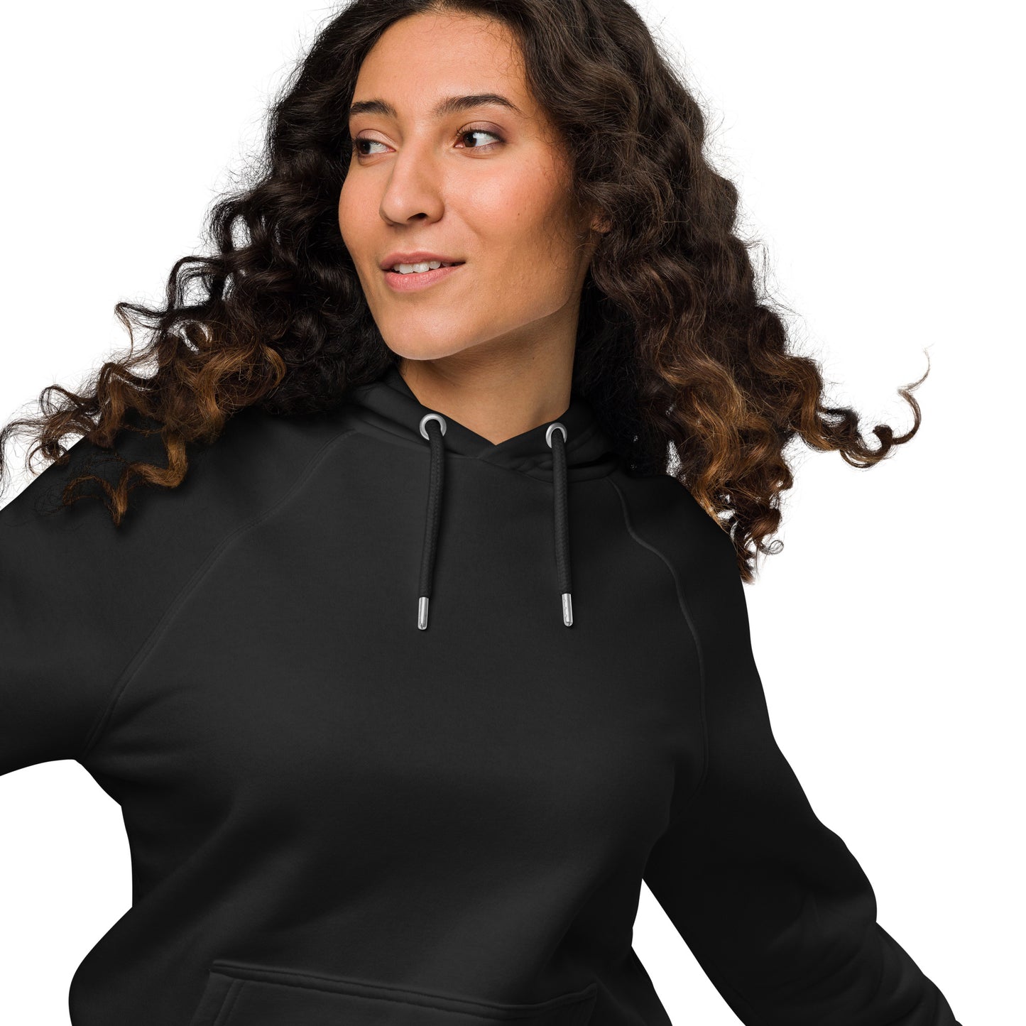 Woman wearing black unisex eco raglan hoodie — relaxed minimalist outfit.