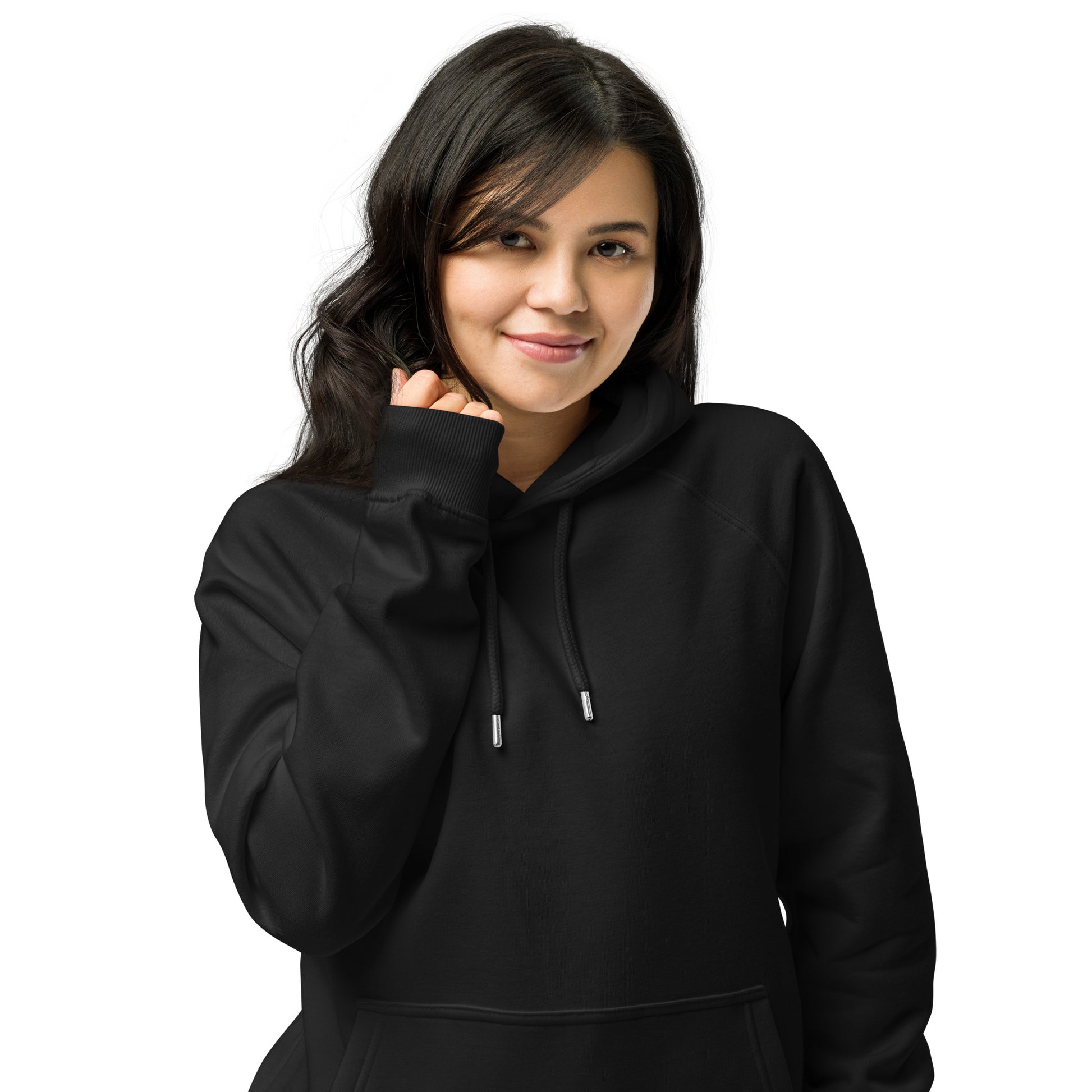 Woman wearing black unisex eco raglan hoodie — relaxed minimalist outfit.