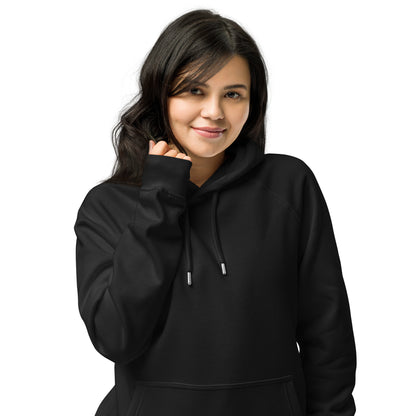 Woman wearing black unisex eco raglan hoodie — relaxed minimalist outfit.