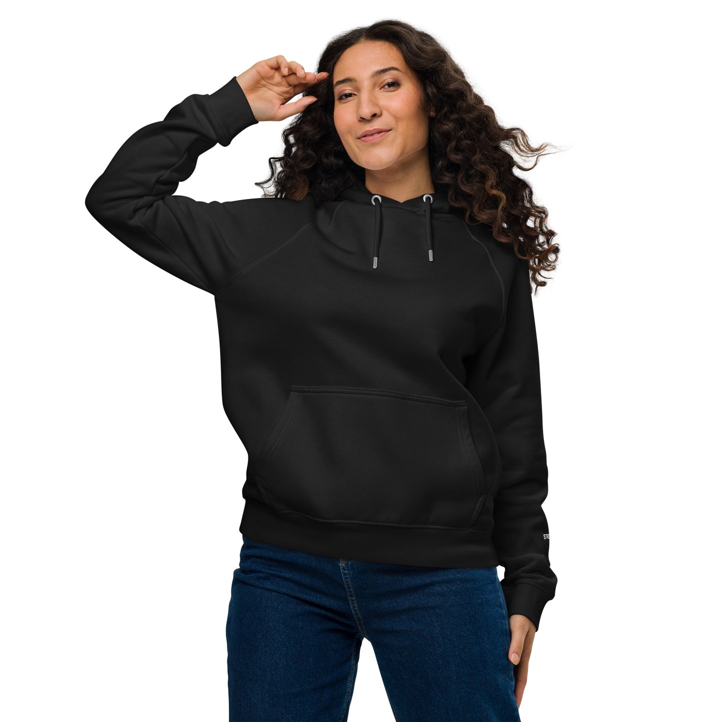 Woman wearing black unisex eco raglan hoodie — relaxed minimalist outfit.