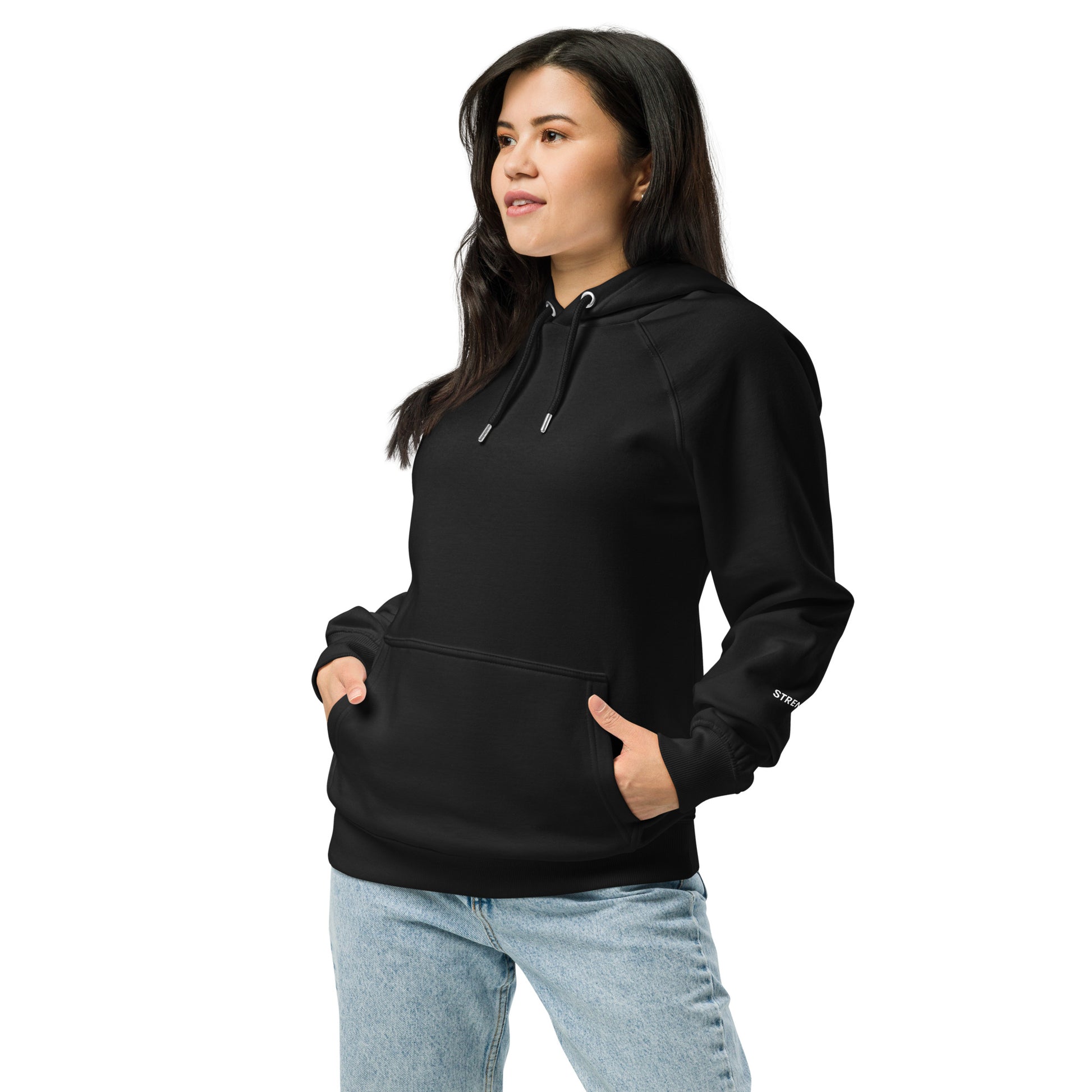 Woman wearing black unisex eco raglan hoodie — relaxed minimalist outfit.