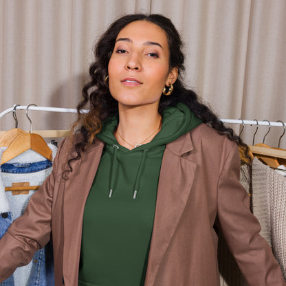 Woman wearing a bottle green organic cotton hoodie with serenity sleeve print, relaxed unisex fit.
