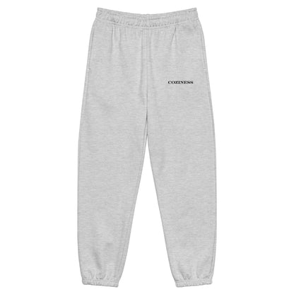 Heavyweight sweatpants in Athletic Heather with soft brushed fleece, black “coziness” embroidery, elastic cuffs, and roomy street-style fit.