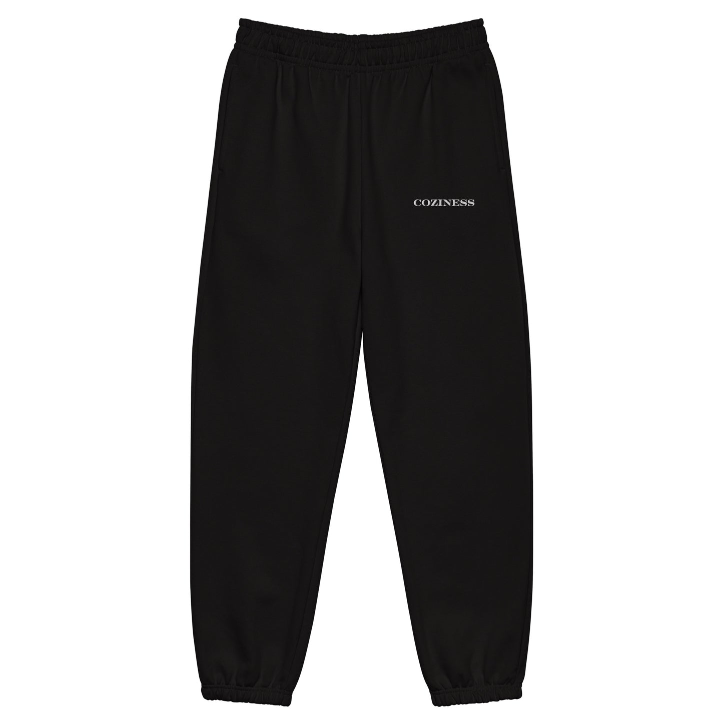 Heavyweight sweatpants in Black with soft brushed fleece, white “coziness” embroidery, deep side pockets, elastic cuffs, and relaxed street-style fit.