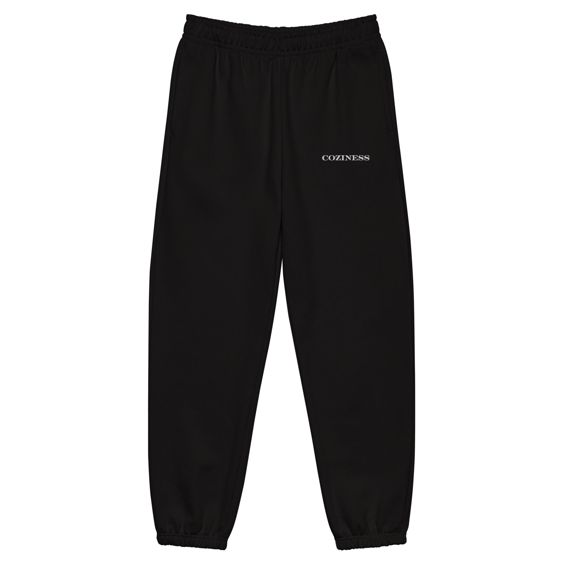Heavyweight sweatpants in Black with soft brushed fleece, white “coziness” embroidery, deep side pockets, elastic cuffs, and relaxed street-style fit.