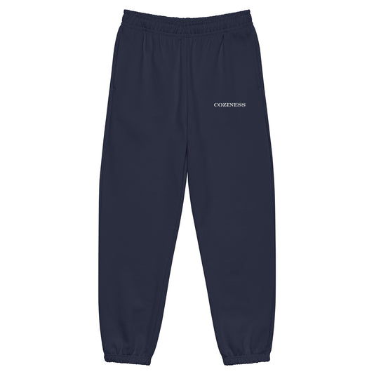 Heavyweight sweatpants in Navy with soft brushed fleece, white “coziness” embroidery, elastic cuffs, and roomy street-style fit.