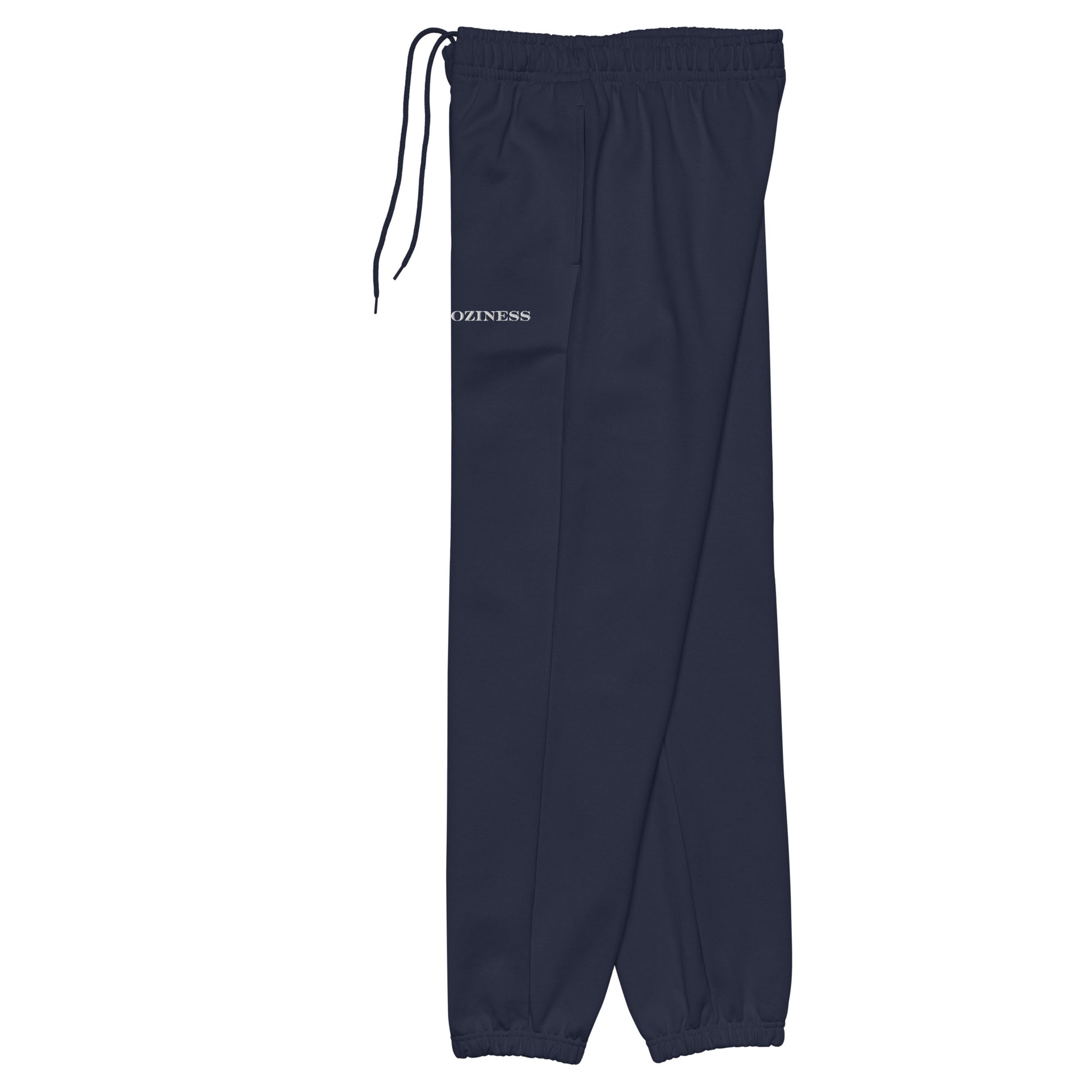 Side view of heavyweight sweatpants in Navy with white “coziness” embroidery, elastic cuffs, and relaxed street-style fit.