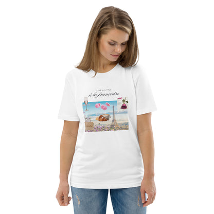 Woman wearing white graphic tee with Parisian design — soft pink and blue illustration with Eiffel Tower, macarons and rose, Island of Calm brand