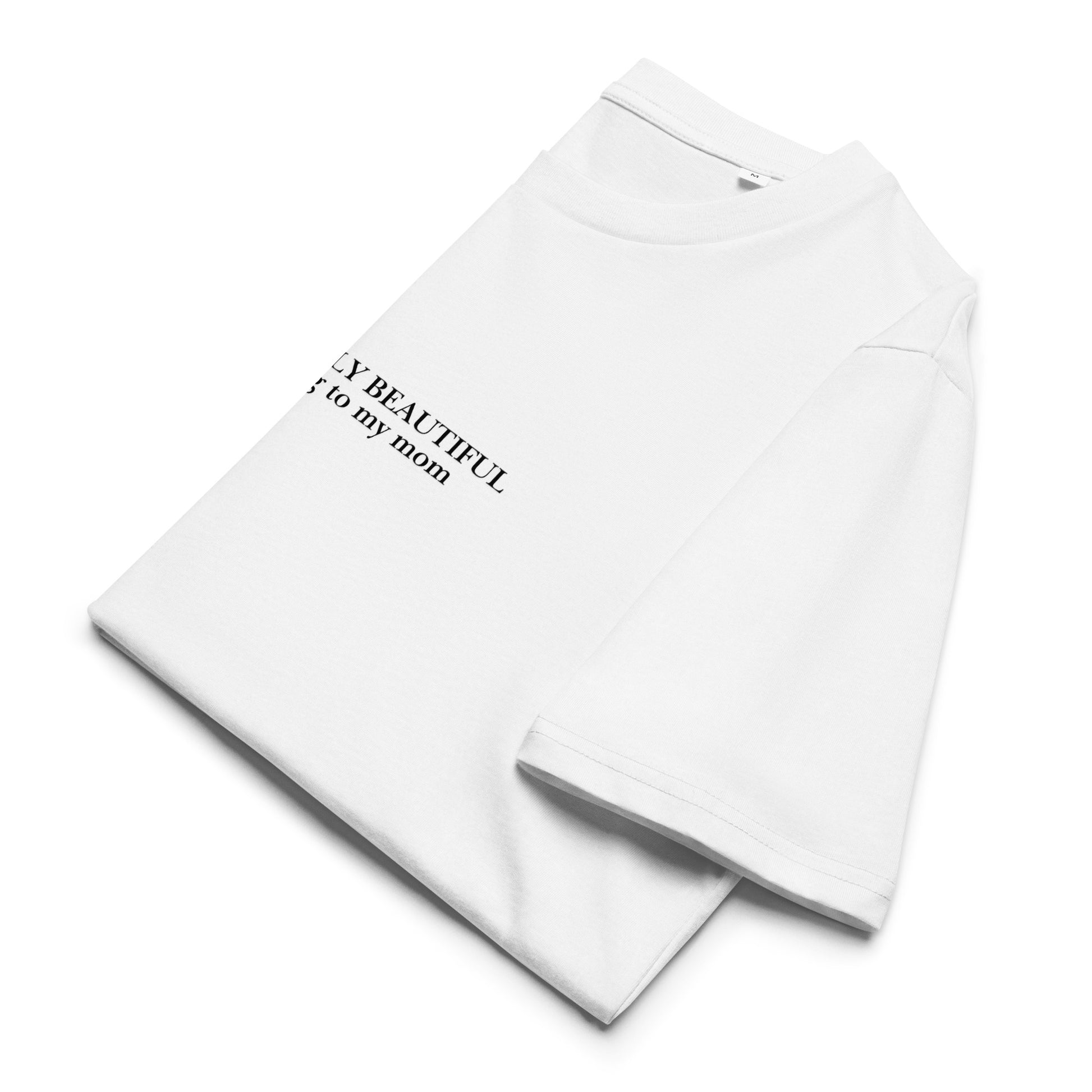 Close-up of "Absolutely Beautiful According to My Mom" print on white GOTS-certified organic cotton t-shirt