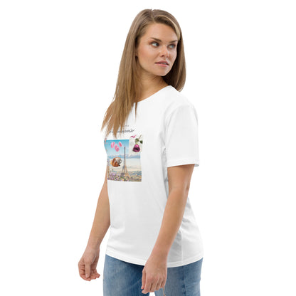 Woman wearing white graphic tee with Parisian design — soft pink and blue illustration with Eiffel Tower, macarons and rose, Island of Calm brand