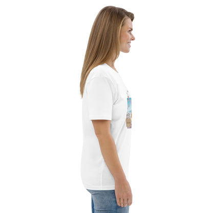Woman wearing white graphic tee with Parisian design — soft pink and blue illustration with Eiffel Tower, macarons and rose, Island of Calm brand