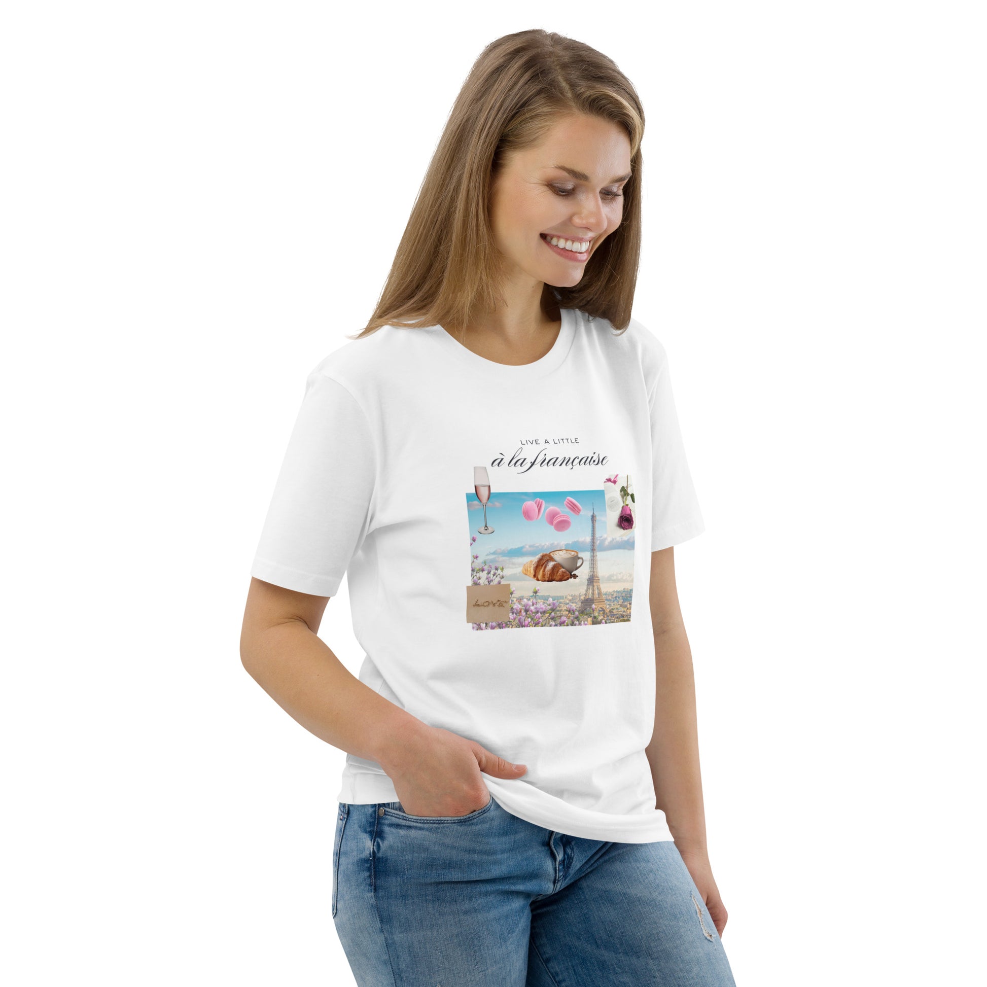 Woman wearing white graphic tee with Parisian design — soft pink and blue illustration with Eiffel Tower, macarons and rose, Island of Calm brand